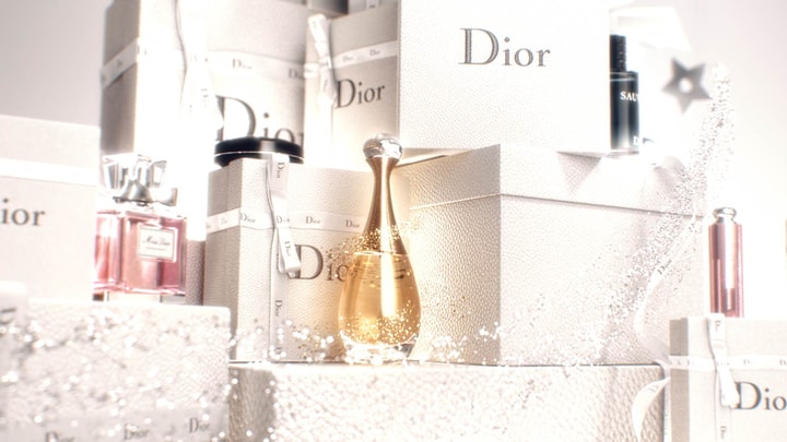 3D Motion Design with Dior products on top of gift boxes with magical particles