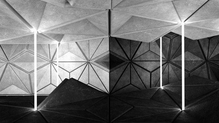 Neon lights inside an abstract and geometric environment made of concrete blocks