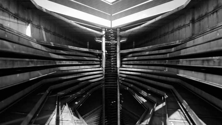 Inside view of an abstract geometric building composed of various concrete strates