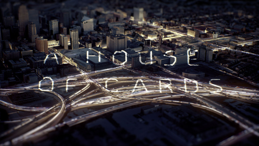 Aerial city shot with luminous particles flow and a text projected with 3D camera mapping